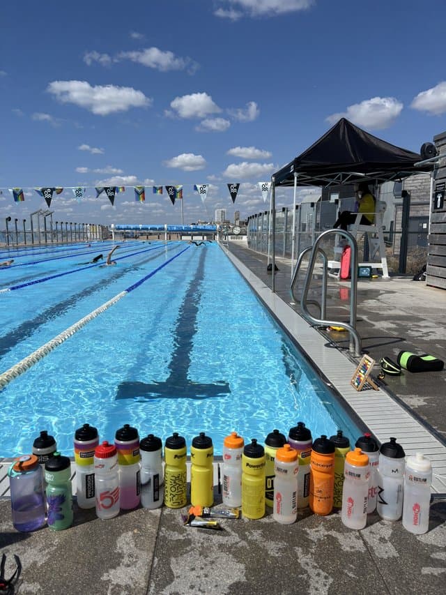 A row of drinks bottles lined up along the poolside
